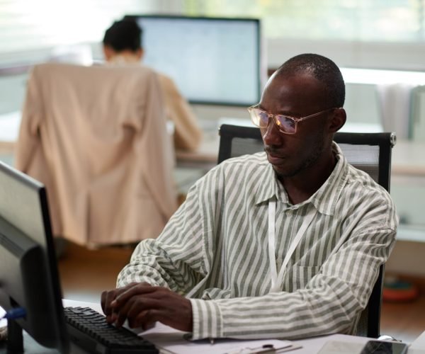 businessman-filling-document-at-office-desk-2025-01-29-08-29-07-utc (1) (1)